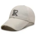 Detailed view of the beige mesh baseball cap featuring a bold 3D embroidered letter R front. - Adjustable / Off White