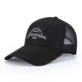 Black mesh baseball cap closeup showcasing breathable fabric and front embroidery details. - Adjustable / Black