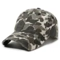 Washed camo baseball cap detail view showing the distressed fabric and metal badge design. - Adjustable / Off White