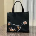 Schwarze isolierte Lunchtasche mit süßem Cartoon-Bären, wasserdichte tragbare Bento-Tasche. - Schwarzer Bärenkopf