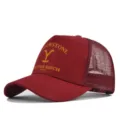 Detailed view of the maroon Yellowstone Dutton Ranch trucker mesh baseball cap with bold yellow print. - Adjustable / Burgundy