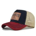 Detailed close-up view of the Brooklyn leather patch and mesh back baseball cap. - Burgundy & Navy