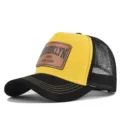 Detailed view of yellow and black mesh baseball cap with BROOKLYN leather patch. - Black Yellow