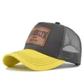 Stylish Brooklyn patch trucker hat with breathable mesh back and yellow curved brim. - Yellow/Gray