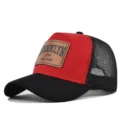 Red and black trucker hat with brown leather patch, breathable mesh back and curved brim. - Black & Red (Black Stitch)