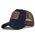 Detailed view of the summer fishing mesh baseball cap with a vintage brown leather patch. - Adjustable / CM817-41 Navy Coffee Mesh
