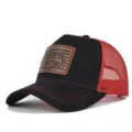Detail shot of black mesh trucker hat featuring a brown leather patch with a fishing graphic. - Adjustable / CM817-44 Black with Bright Red Mesh