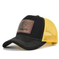 Close-up detail of black and yellow trucker hat with outdoor hunting leather patch design. - Adjustable / CM816-43 Black with Yellow Mesh