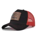 Close-up detail of the black and red trucker hat featuring a rustic leather patch. - Adjustable / CM816-44 Black with Bright Red Mesh