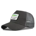 Dark grey trucker hat with embroidered mahi-mahi fish logo for summer outdoor fishing. - Adjustable / Dark Gray
