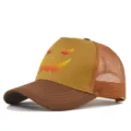 Close-up detail of the Halloween pumpkin print mesh baseball cap with breathable brown design. - Light Coffee/Caramel