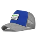 Close-up detail of blue and grey trucker hat with embroidered fish patch and breathable mesh back. - Adjustable / Light Gray & Blue (Large Thread)