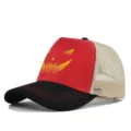 Halloween trucker hat detail featuring red pumpkin face print and black curved brim. - Black And Red-Beige Mesh