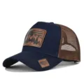 Detailed view of the mesh trucker hat featuring a brown leather patch with a deer design. - Adjustable / Navy Blue Coffee Mesh (CM802-33)