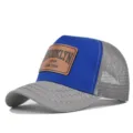 Blue and grey trucker hat with breathable mesh back and vintage leather patch detail. - Light Gray/Blue Large Embroidered