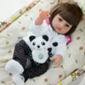 45cm reborn baby doll vinyl simulation infant toy with white outfit and cute panda toy. - White Jacket Polka Dot Pants Panda Style (Q18-071-070)
