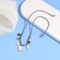 Boho braided anklet detail featuring letter N pendant, pearls and shell charms for beach summer. - Letter N