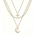 Layered gold necklace featuring star and moon pendants with crystal accents and initial letter K. - Style K