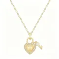 Detailed view of gold heart lock and key pendant necklace with crystal pave and letter T. - Letter T
