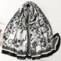 Detail view of a vintage black and white floral printed long scarf, elegant lace border design. - 180x85cm / Black and White Floral (SL2609-013)