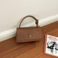 Chic woven shoulder bag for women, stylish brown handbag with metal clasp and unique handle. - Tan