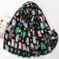Black scarf with cute colorful cat print, soft cotton linen material, stylish shawl accessory. - Black