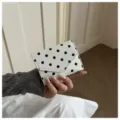 White black polka dot wallet detail showing the compact trifold design and classic print. - White