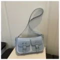 Trendy light blue crescent shoulder bag with double pockets and chic metal buckle design. - Blue