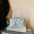 Bolso de hombro monocolor minimalista para mujer con elegante colgante de lazo de perlas. - Con Colgante / Azul