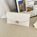 White textured envelope clutch bag with gold irregular metal clasp for women stylish commute. - White
