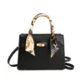 Classic black women handbag with stylish scarf decorated handle and elegant gold hardware design. - Black