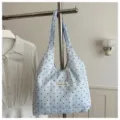 Detailaufnahme der blauen gepunkteten Spitzentasche am Hänger, Stoffstruktur und Etikett. - Ohne Anhänger / Blau