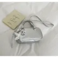 Silver metallic boston handbag detail with star pendant, glossy finish and dual handles. - Silver (With Pendant)