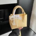 Gelbe Mini Handtasche für Damen, stilvolle Kunstleder Beuteltasche mit Perlen Schleife. - Gelb