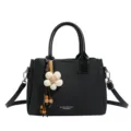 Black leather shoulder bag with floral pendant, stylish top handle bucket bag for women. - Black