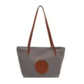 Grey nylon tote bag with brown leather handles and circular front patch for women daily use. - Light Gray Large