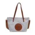 Grey Oxford cloth tote bag with brown leather handles and chic circular front patch variant. - Light Blue Small