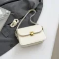 Elegant minimalist white crossbody bag with gold lock hardware, retro single shoulder design. - White