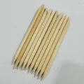 Double-ended wooden cuticle sticks for nail art, detail view showing smooth natural wood texture. - 11.4cm Long * 3.8mm