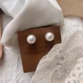 Elegant white pearl stud earrings on wooden display with lace and fabric background, chic minimalist style. - 66# Silver Post Earrings - White 12mm