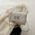 White quilted shoulder bag for women with chic silver bow and chain strap, trendy fashion purse. - White