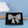 Detailed view of the elegant black velvet evening bag featuring sparkling crystal bow and handle. - Metal Chain / 20*5.5*23cm / Black