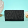 Detail view of a black pleated evening clutch bag, elegant design for parties and banquets. - Black