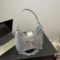 Stijlvolle zilveren schoudertas voor dames met metalen strik en ketting, chique handtas. - Zilver