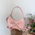 Pink patent crescent shoulder bag with cute bow and metal ball detail, stylish mini handbag. - Pink