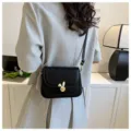 Black crossbody shoulder bag for women, trendy small square bag with cute bunny lock design. - Black