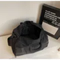 Details of black travel duffel gym bag with large capacity, grid bottom and spacious interior. - Black