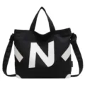 Schwarze Canvas Umhängetasche Tote Bag mit weißem N Logo für Freizeit und Alltag. - Schwarz (Weiße Buchstaben)