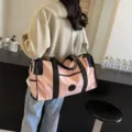 Stylish pink travel duffel bag with black handles, large capacity, perfect for gym or trips. - Oxford Fabric Style / Pink