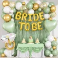 Detailed view of the elegant sage green and gold BRIDE TO BE balloon arch party backdrop setup. - Wedding Green